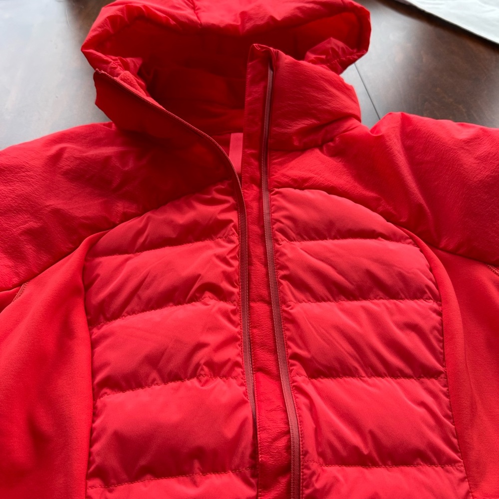LULULEMON down for it all Jacket in Grenadine red.  Never worn with tags